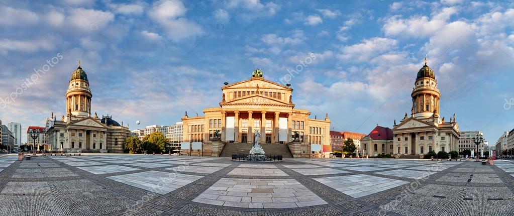 Tiny bird with pale brown, orange and white feathers in an evergreen tree.